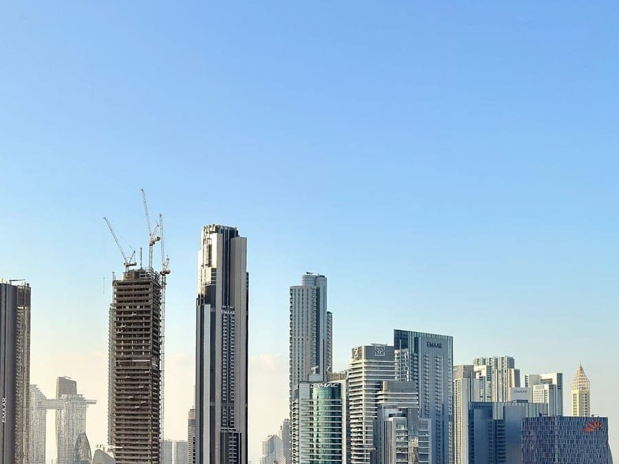 Dubai towers under construction with a tower crane above the skyline